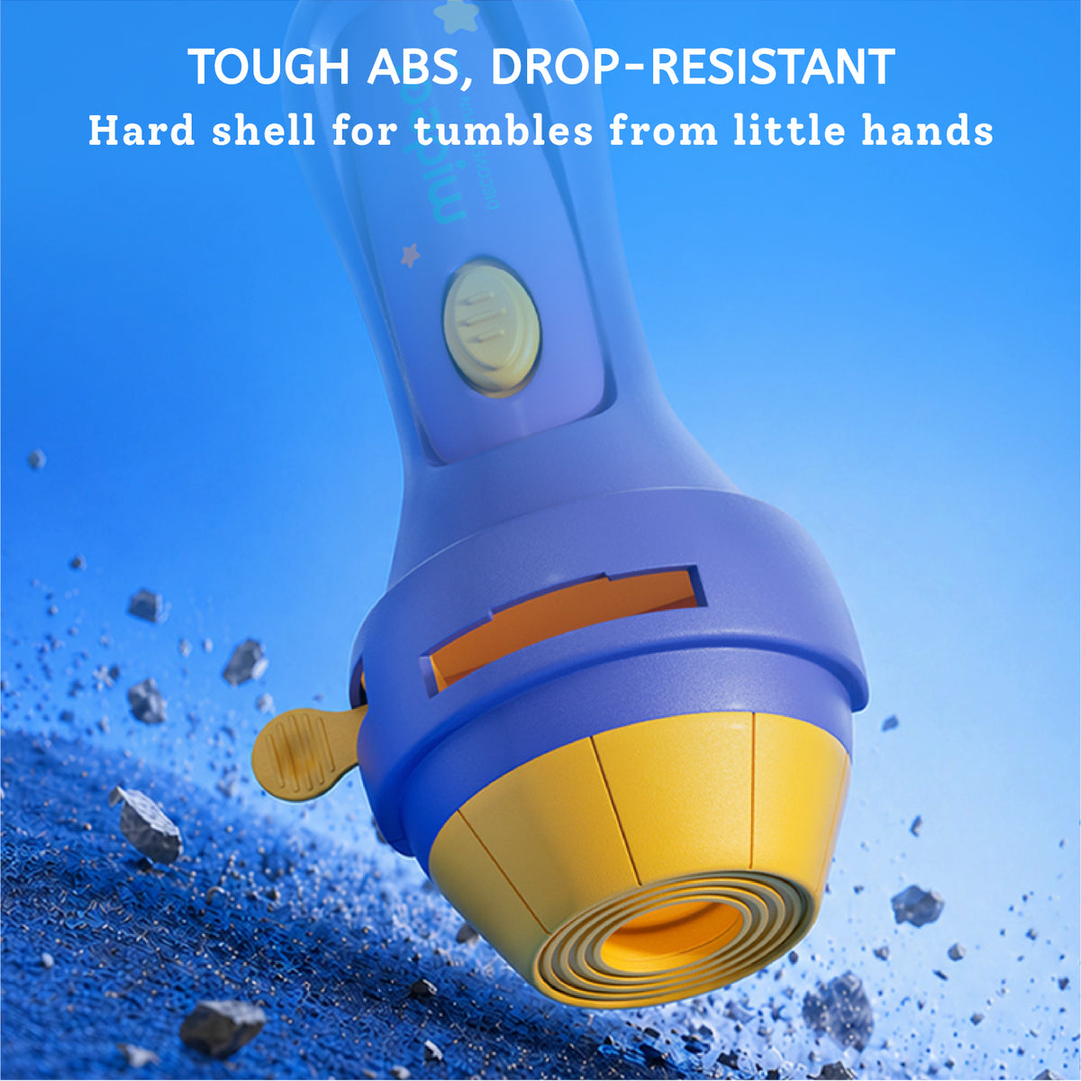 A blue and yellow flashlight shown against a bright blue background with text reading 'TOUGH ABS, DROP-RESISTANT' and 'Hard shell for tumbles from little hands.' The flashlight is angled diagonally, with small dark debris scattered near the bottom left.