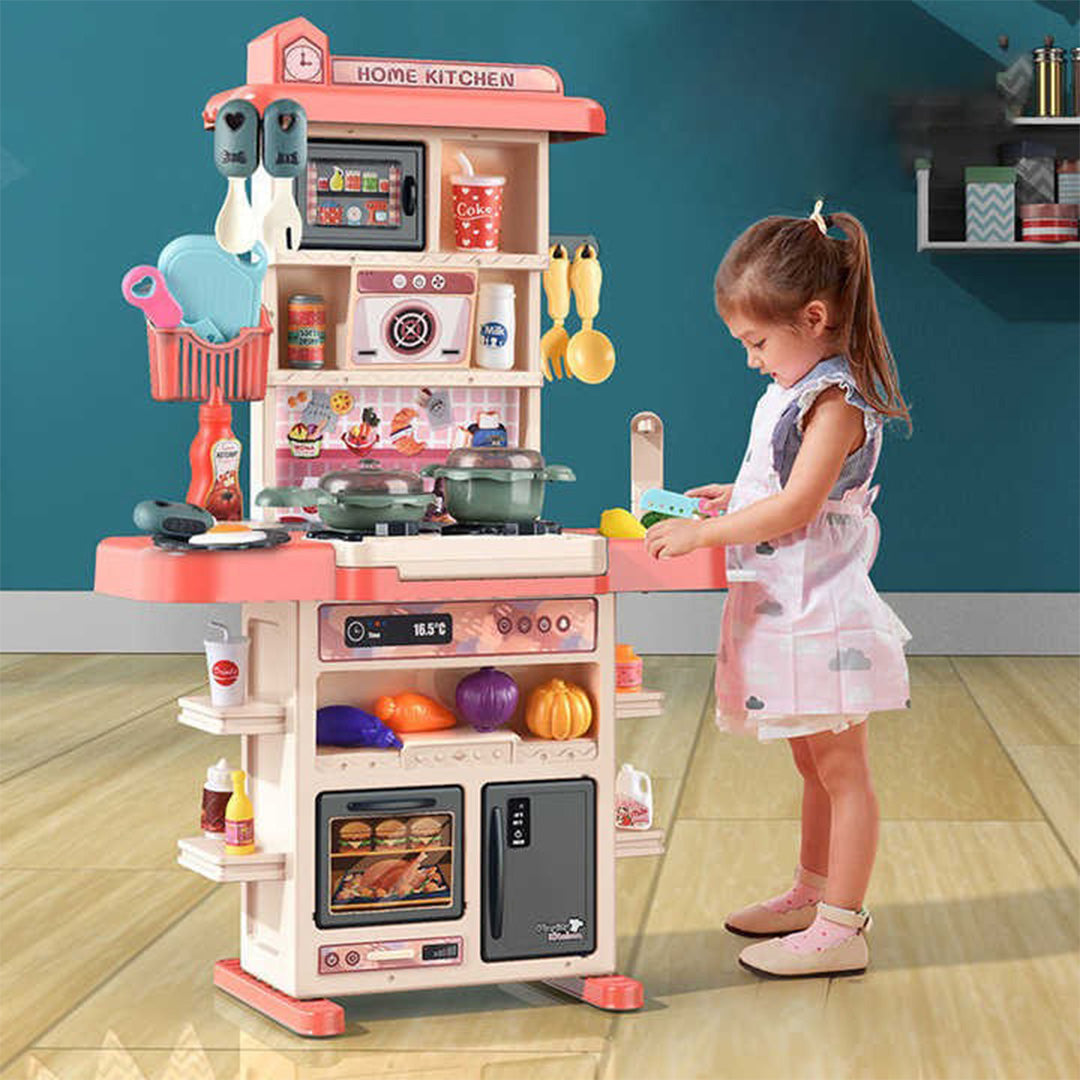 A child playing with the water circulation system in the kids kitchen set.
