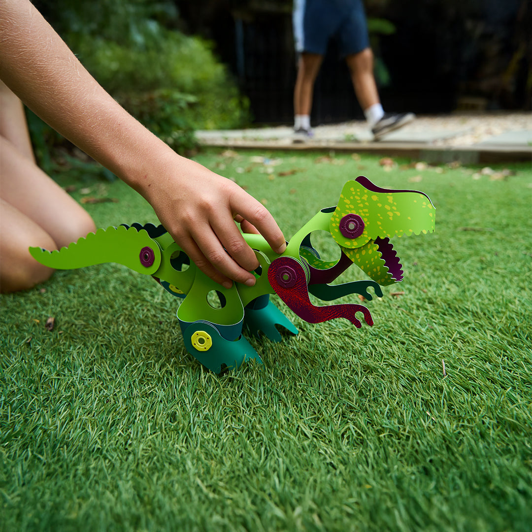 Montessori-inspired colorful Jurassic dinosaur magnetic builder shapes for open-ended play.
