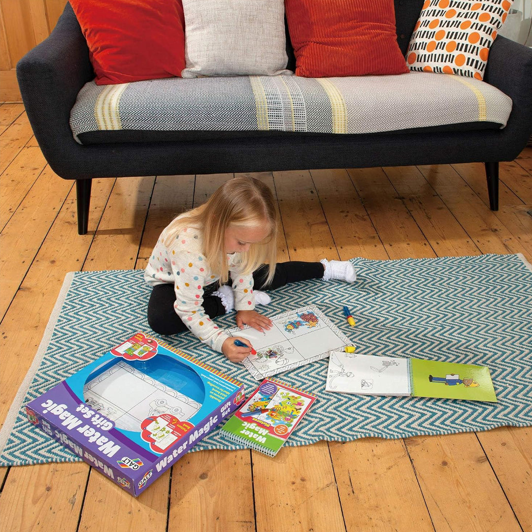 Preschooler using a water pen on educational toys for kids coloring book