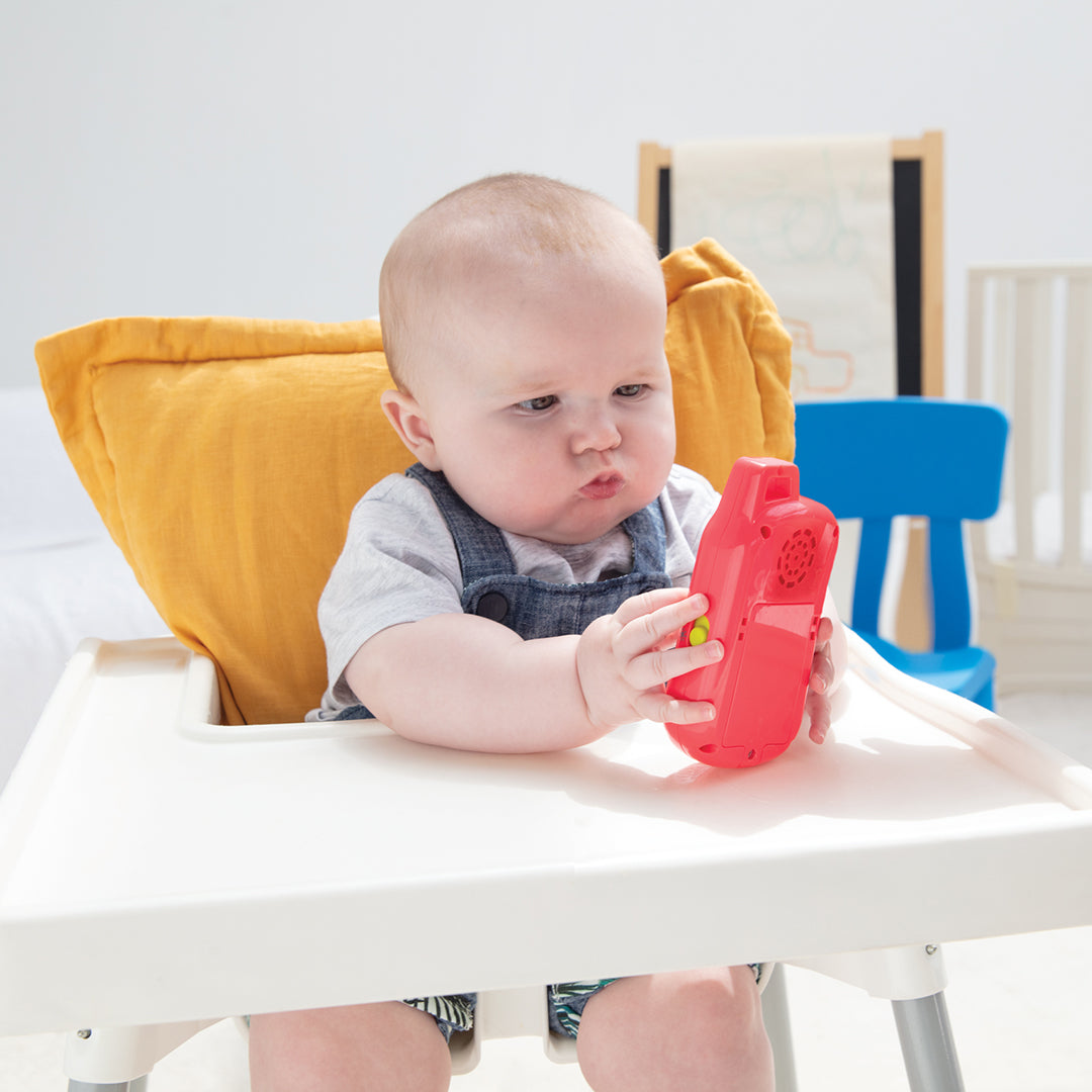 Baby exploring the different sounds and melodies on the Selfie Phone Toy