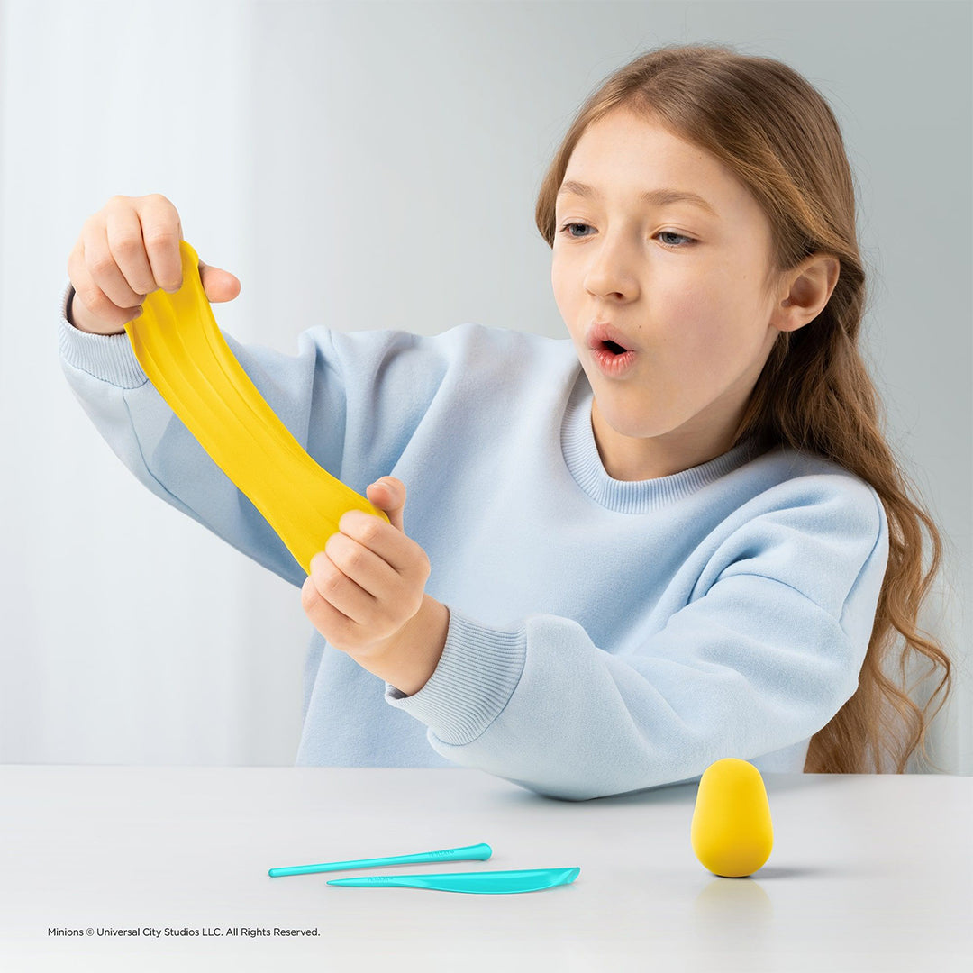 Child using sculpting tools to improve hand-eye coordination.
