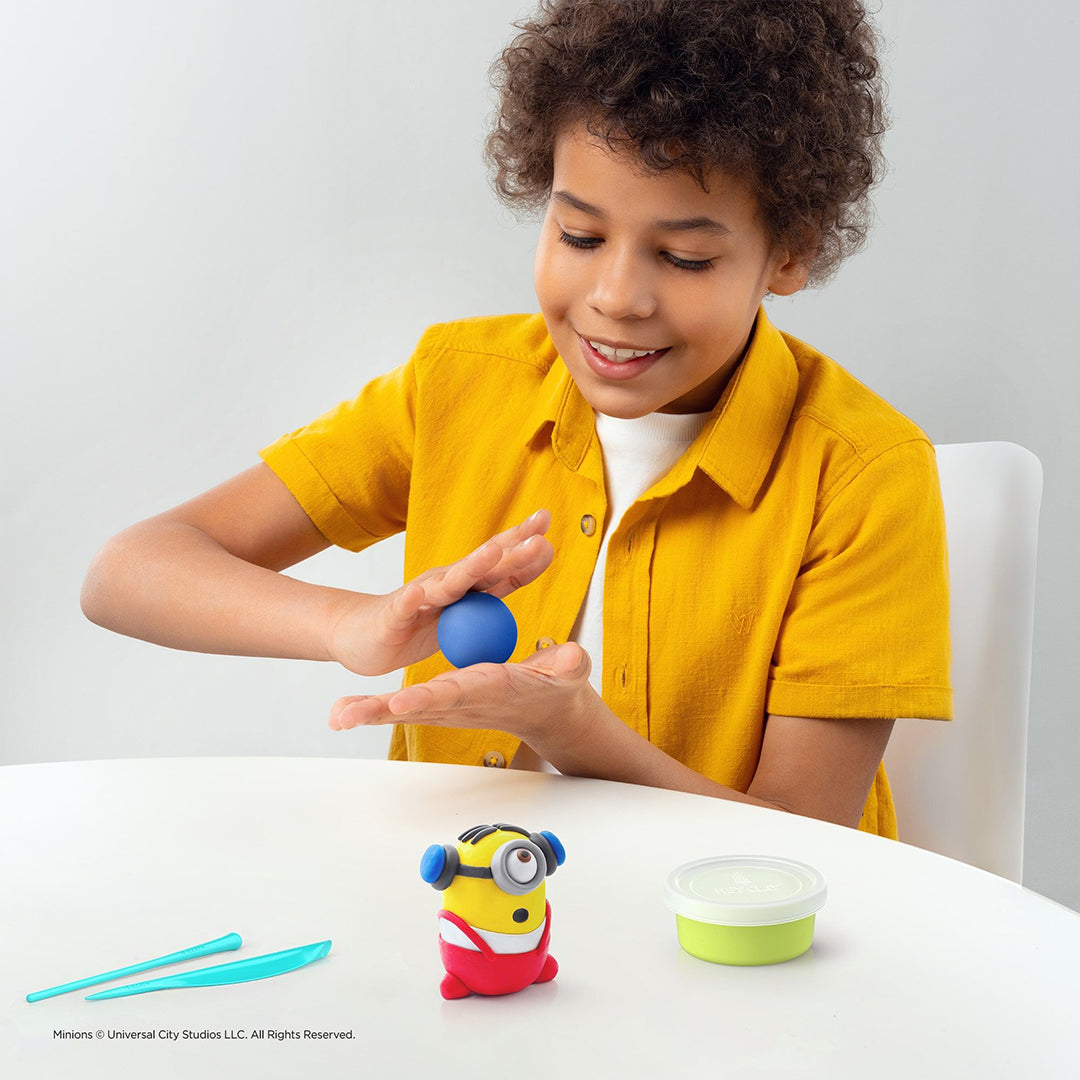 Child using sculpting tools to improve hand-eye coordination.
