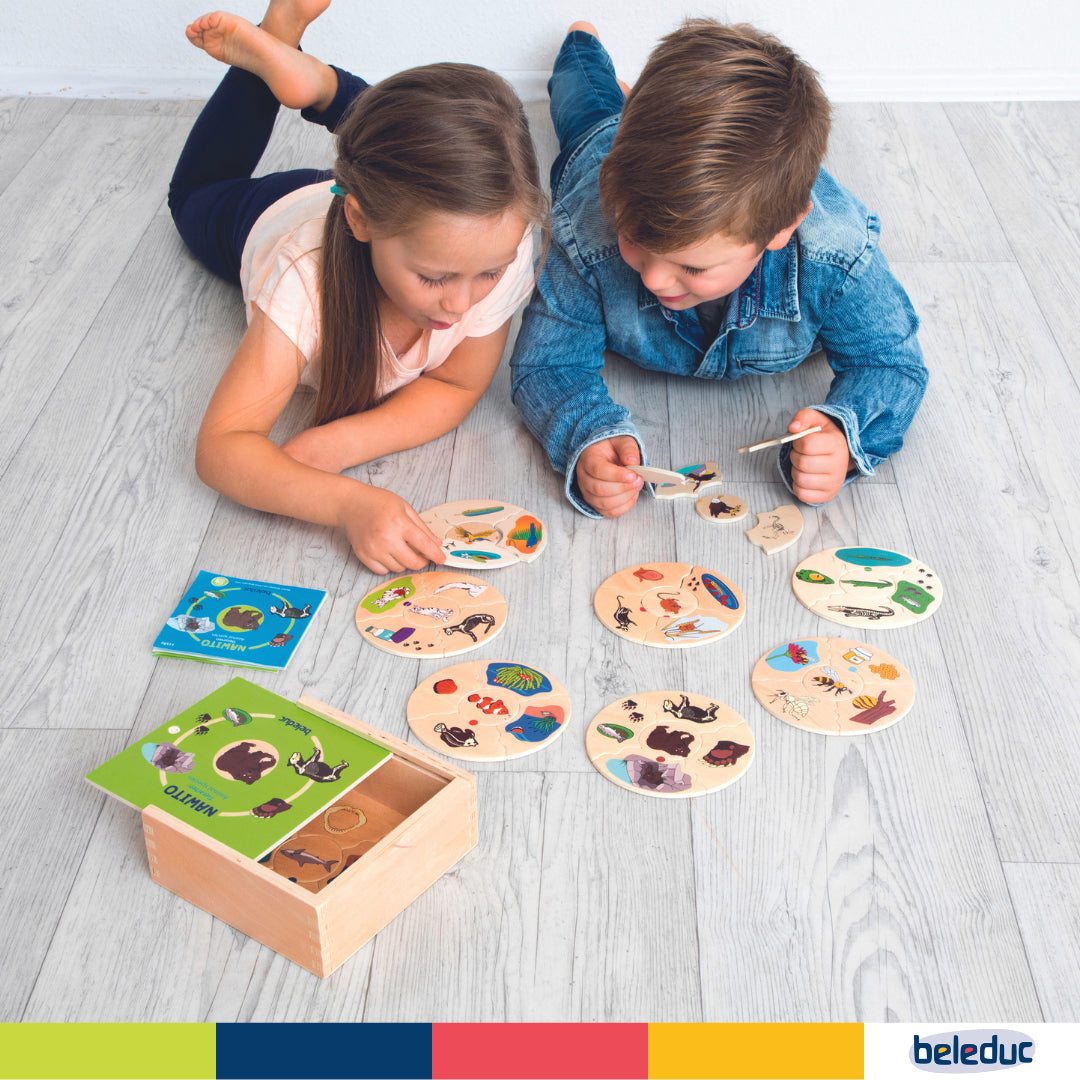 Preschool self-correcting animal skeleton tiles in a wooden storage box for activity toys.

