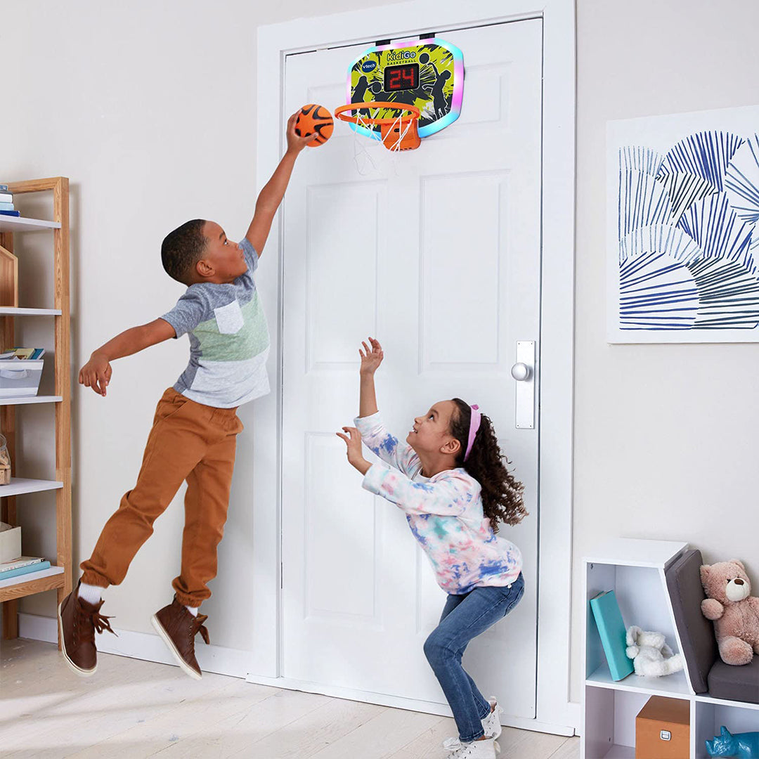 Kids playing basketball with interactive scoreboard for sensory stimulation.
