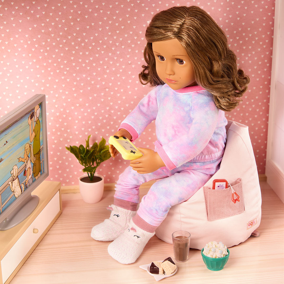 Child playing with the Our Generation Luna Doll and accessories