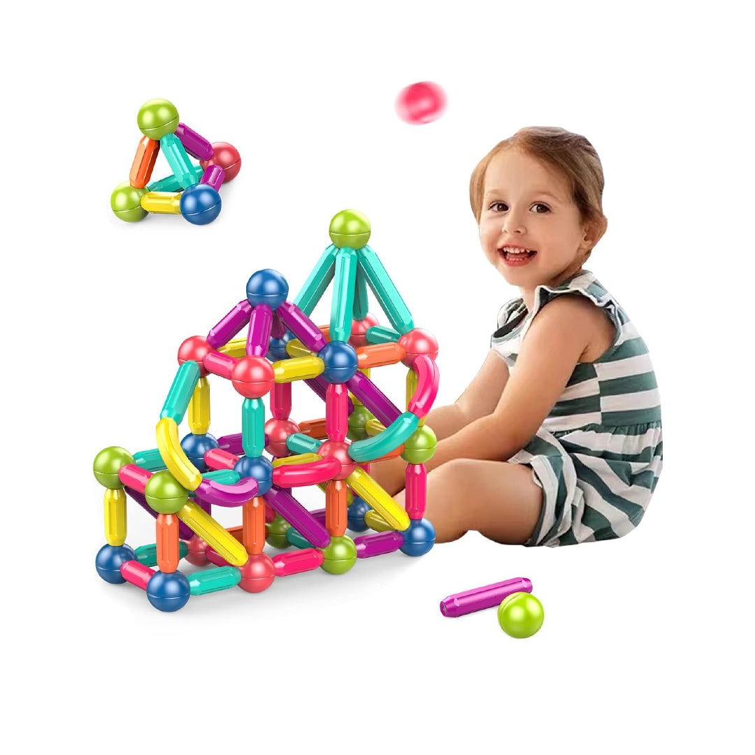 Child building a 3D house with the colorful magnetic blocks
