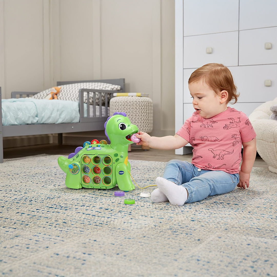 Toddler Feeding Colorful Food Pieces to VTech Dino Toy
