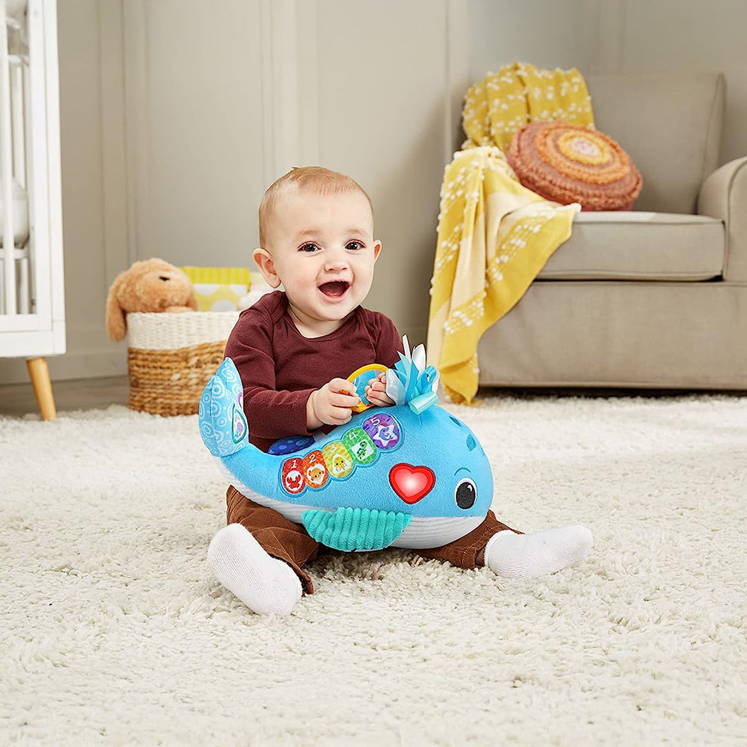 Newborn Playing with Eco-Friendly Plush Whale from Recycled Bottles