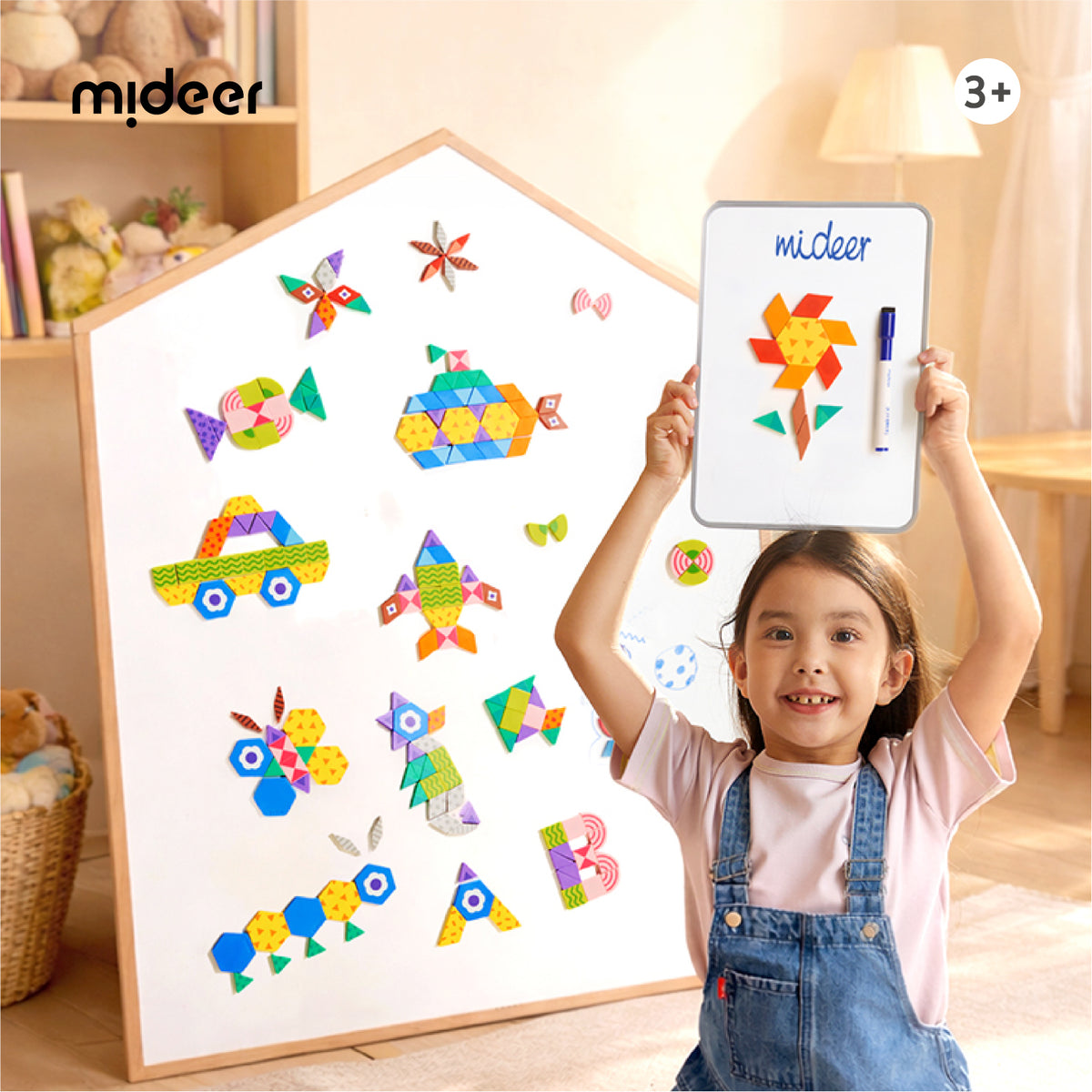 A young child in denim overalls holds up a white magnetic board with colorful geometric shapes and the brand name 'mideer' written on it, while a larger matching magnetic board leans against a wall in a warm, toy-filled room. The middeer logo is visible in the top left, and a '3+' age icon appears in the top right.