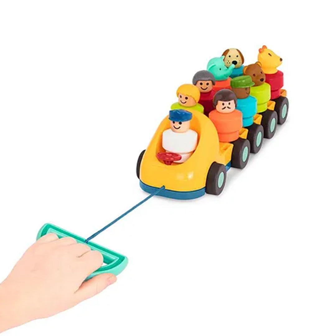  A happy toddler pulls the Battat Spinning Bus Toy string and watches the characters spin.